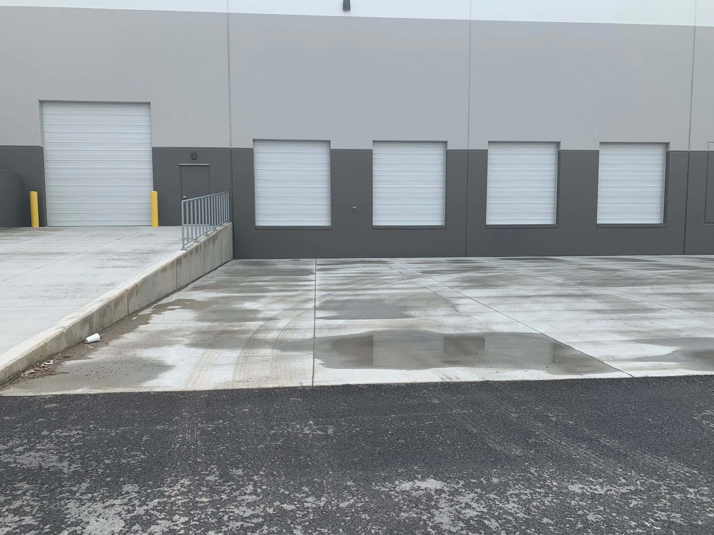 Multiple rolling steel overhead doors on commercial warehouse