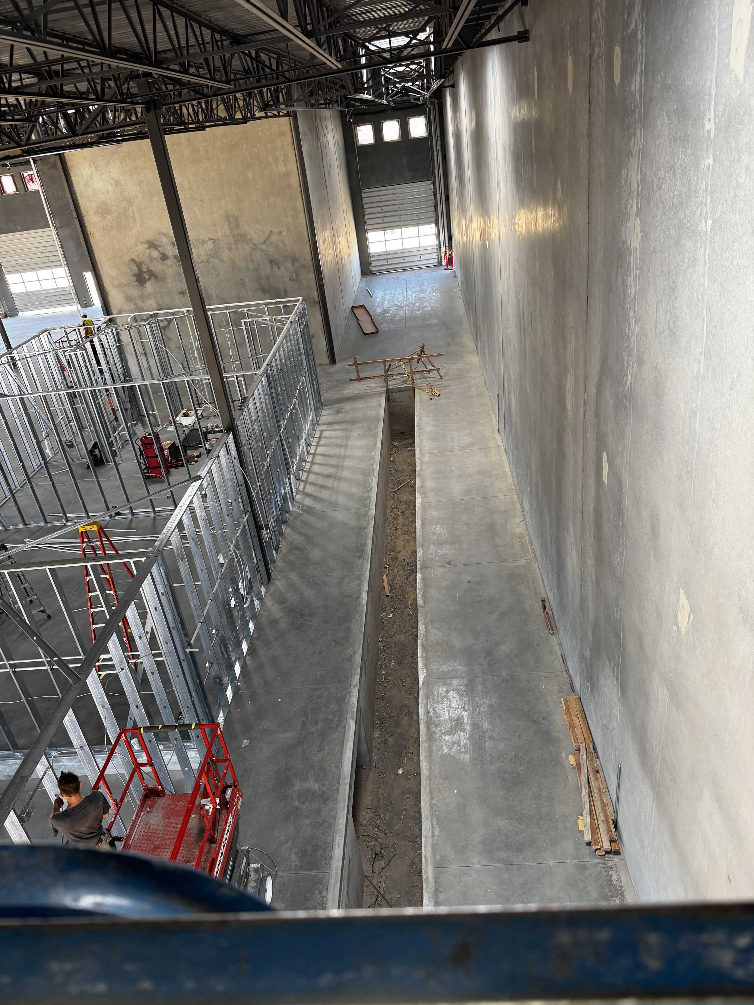 Loading dock with dock leveler and overhead door