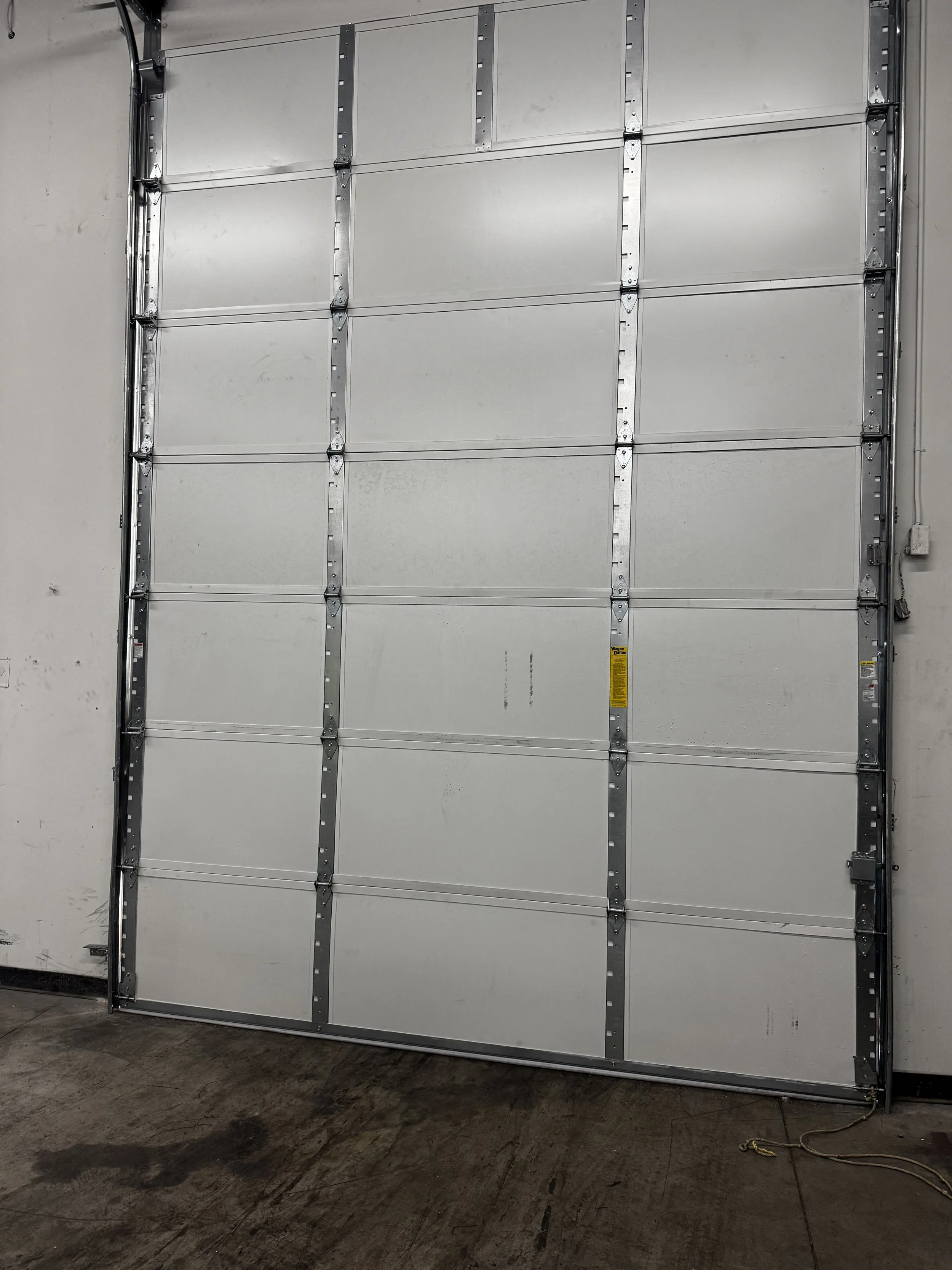 Dock leveler and bumpers at loading dock